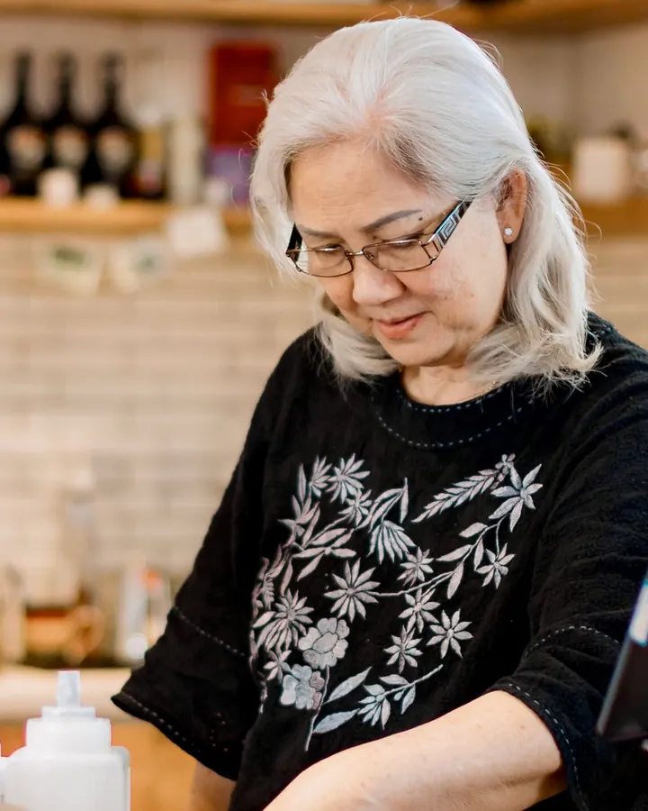 A shop owner at work behind her counter.